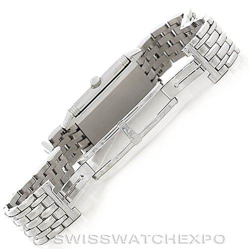 This image shows a side angle of the Jaeger-LeCoultre Reverso watch focusing on its steel case, crown, and bracelet.