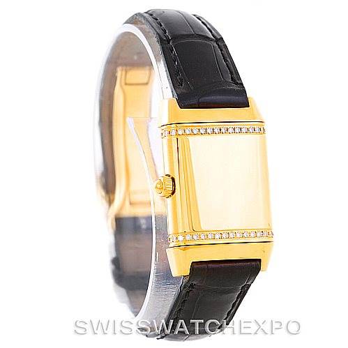 This image shows a side angle of the Jaeger LeCoultre Reverso 265.1.08 Women's Yellow Gold Mother of Pearl Dial 265.1.08 Women's Yellow Gold Mother of Pearl Dial watch, highlighting its gold case, side crown, and black leather strap.