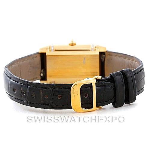 The Jaeger LeCoultre Reverso 265.1.08 Women's Yellow Gold Mother of Pearl Dial 265.1.08 Women's Yellow Gold Mother of Pearl Dial watch is shown from the back, displaying the gold case and black leather strap with buckle.