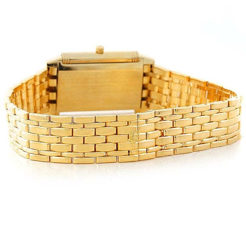 This image shows the backside and bracelet of a Jaeger-LeCoultre Reverso watch in gold.