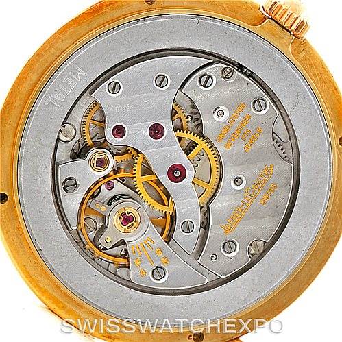 The image shows the inner mechanical workings of a vintage Jaeger-LeCoultre watch, viewed from the back at a close-up angle.