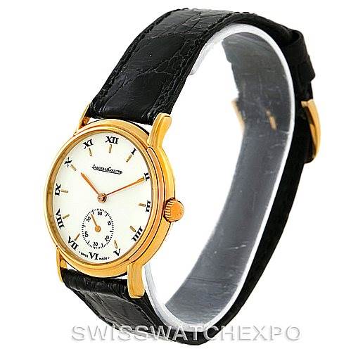 This image shows a side angle of a Jaeger LeCoultre Vintage 162.7.81 Men's Yellow Gold White Dial 162.7.81 Men's Yellow Gold White Dial watch with a black leather strap and a gold case.