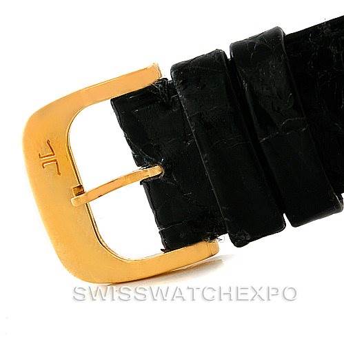 This image shows a close-up of the gold buckle and black leather strap of a Vintage Jaeger LeCoultre watch.
