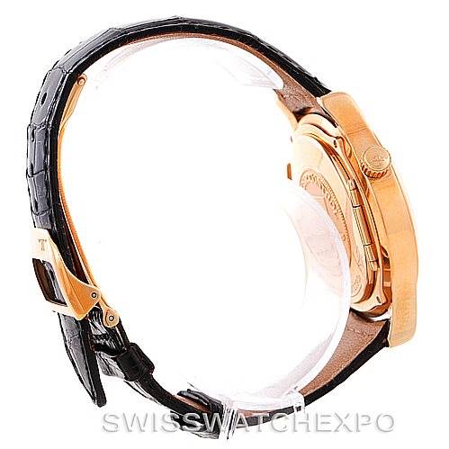 This image shows a side view of a Jaeger LeCoultre Master 142.2.92 Men's Rose Gold Silver Dial 142.2.92 Men's Rose Gold Silver Dial model watch, highlighting its gold case, crown, and black leather strap.