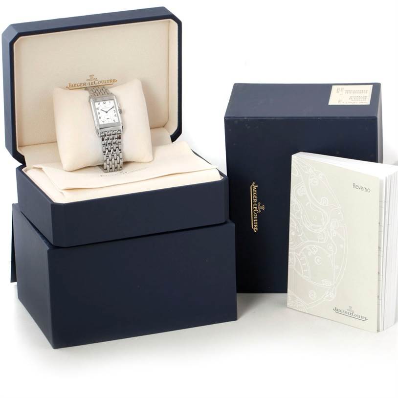 The image shows a Jaeger LeCoultre Reverso 272.8.54 Stainless Steel Silver Dial 272.8.54 Stainless Steel Silver Dial watch in its box, accompanied by its outer box and user manual, all from a front angle.