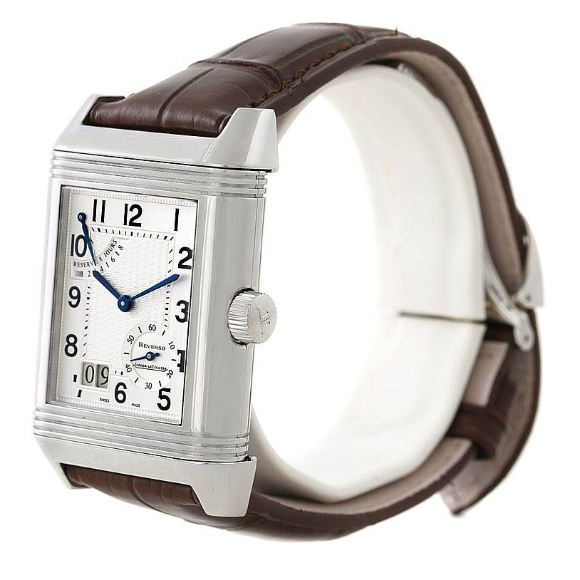 The image shows a Reverso model watch by Jaeger LeCoultre from a left-side angle, displaying its rectangular dial, crown, and leather strap.