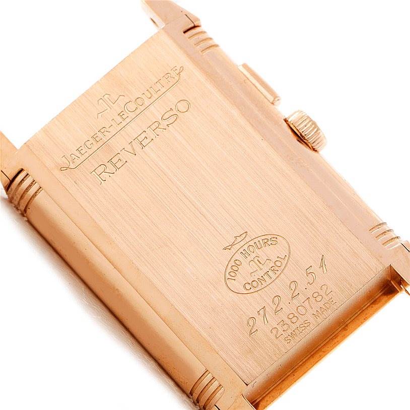 The image shows the back case of a Jaeger-LeCoultre Reverso watch, highlighting the engraving and brand details.