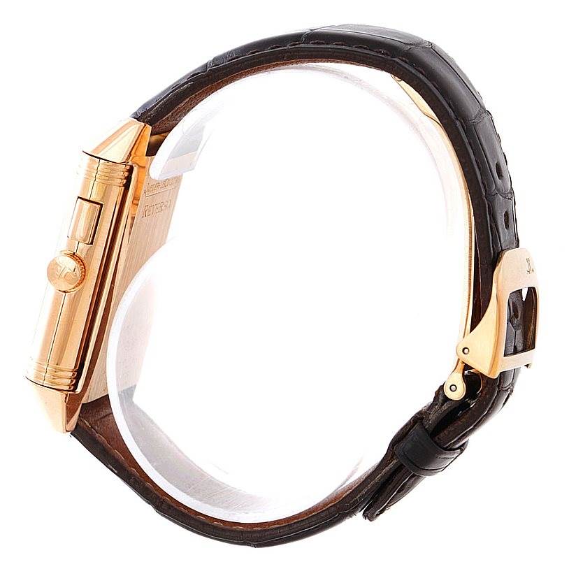 This image shows a side view of a Jaeger LeCoultre Reverso 272.251 Men's Rose Gold Silver Dial 272.251 Men's Rose Gold Silver Dial watch, highlighting its case, crown, and part of the leather strap with buckle.