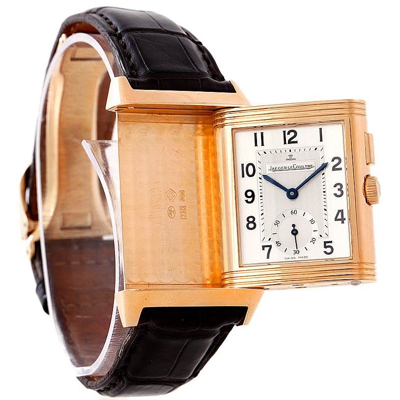 This image shows a Jaeger LeCoultre Reverso 272.251 Men's Rose Gold Silver Dial 272.251 Men's Rose Gold Silver Dial watch with its case flipped, revealing the back and the watch face.