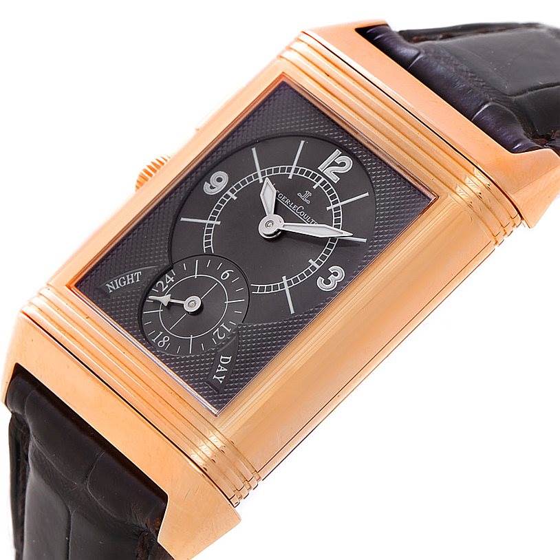 This image shows a Jaeger LeCoultre Reverso 272.251 Men's Rose Gold Silver Dial 272.251 Men's Rose Gold Silver Dial watch from an angled front view, highlighting its dial and strap.
