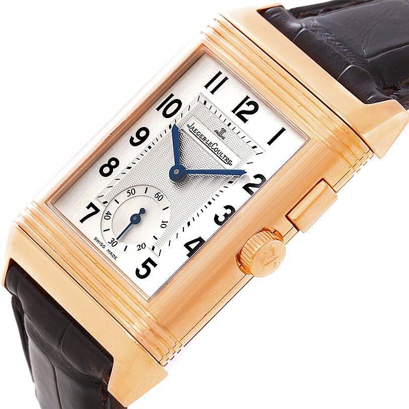 This image shows a close-up side view of the Jaeger LeCoultre Reverso 272.251 Men's Rose Gold Silver Dial 272.251 Men's Rose Gold Silver Dial watch, highlighting its rectangular face, crown, and black leather strap.