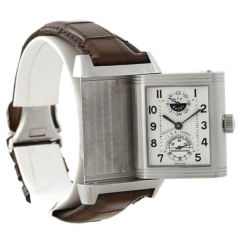 The image shows a Jaeger LeCoultre Reverso 240.8.72 Men's Stainless Steel Silver Dial 240.8.72 Men's Stainless Steel Silver Dial watch at an angle highlighting its reversible case, brown leather strap, and side crown.