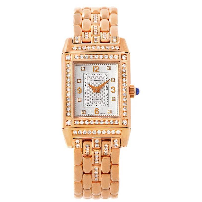 The image shows a front view of a Jaeger LeCoultre Reverso 267.2.86 Women's Rose Gold Silver Dial 267.2.86 Women's Rose Gold Silver Dial watch featuring a gold and diamond-studded case and bracelet.
