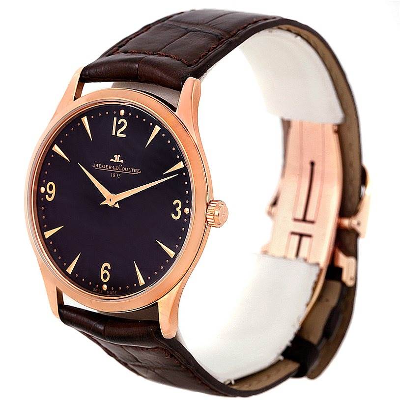 The Jaeger-LeCoultre Master watch is shown at a three-quarter angle, highlighting its face, dial, crown, and leather strap.