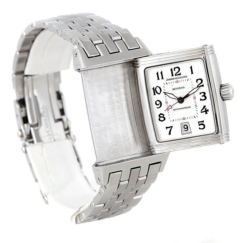 A Jaeger LeCoultre Reverso 290.8.60 Men
s Stainless Steel Silver Dial 290.8.60 Men
s Stainless Steel Silver Dial watch is shown from an angle that highlights its flipping mechanism and stainless steel bracelet.