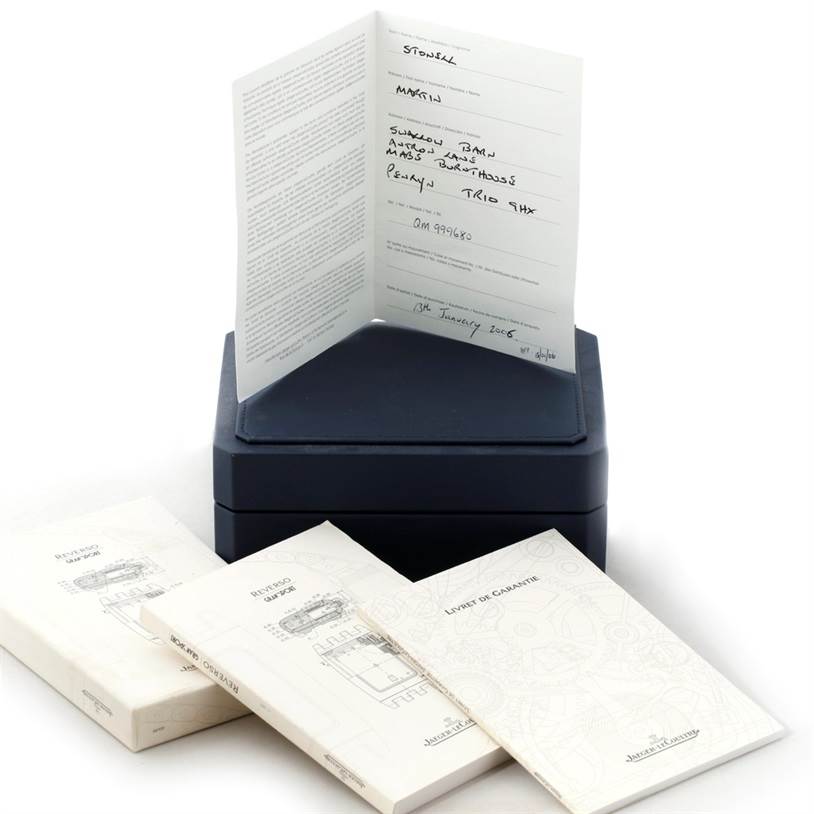 The image shows the Jaeger-LeCoultre Reverso model watch box and accompanying manuals and documents.