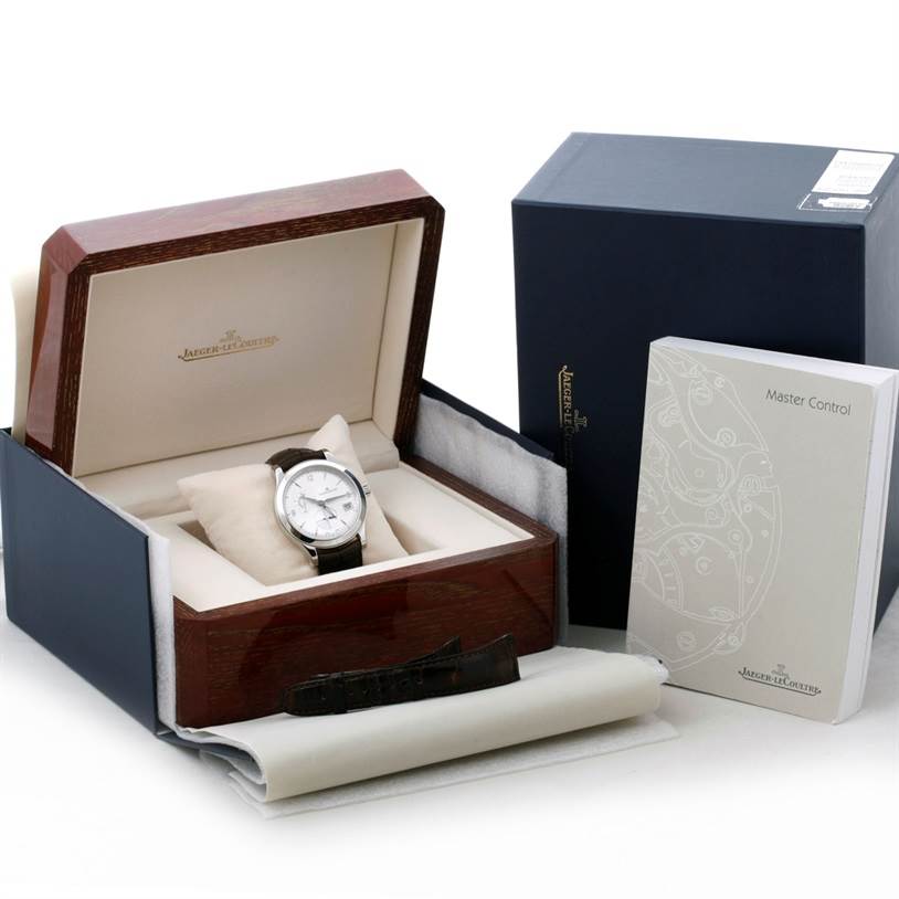 This image shows a Jaeger LeCoultre Master 147.8.05.S Men's Stainless Steel Silver Dial 147.8.05.S Men's Stainless Steel Silver Dial model watch in its box, accompanied by its manual and an additional strap.