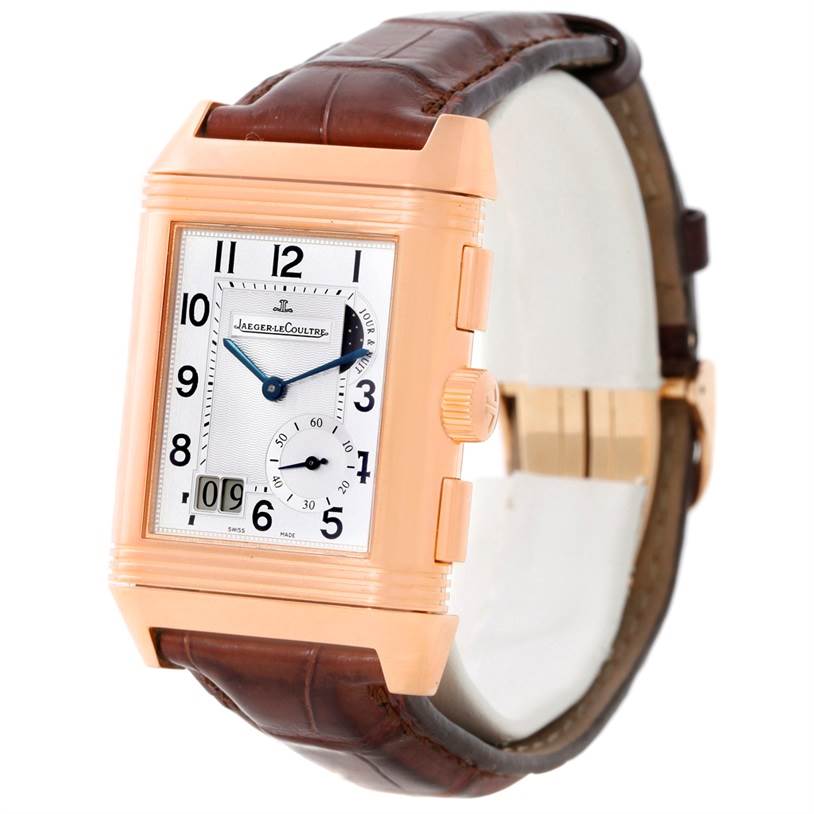 The image shows a Jaeger LeCoultre Reverso 240.2.18 Men
s Rose Gold Silver Dial 240.2.18 Men
s Rose Gold Silver Dial watch from an angled side view, displaying the watch face and part of the leather strap.