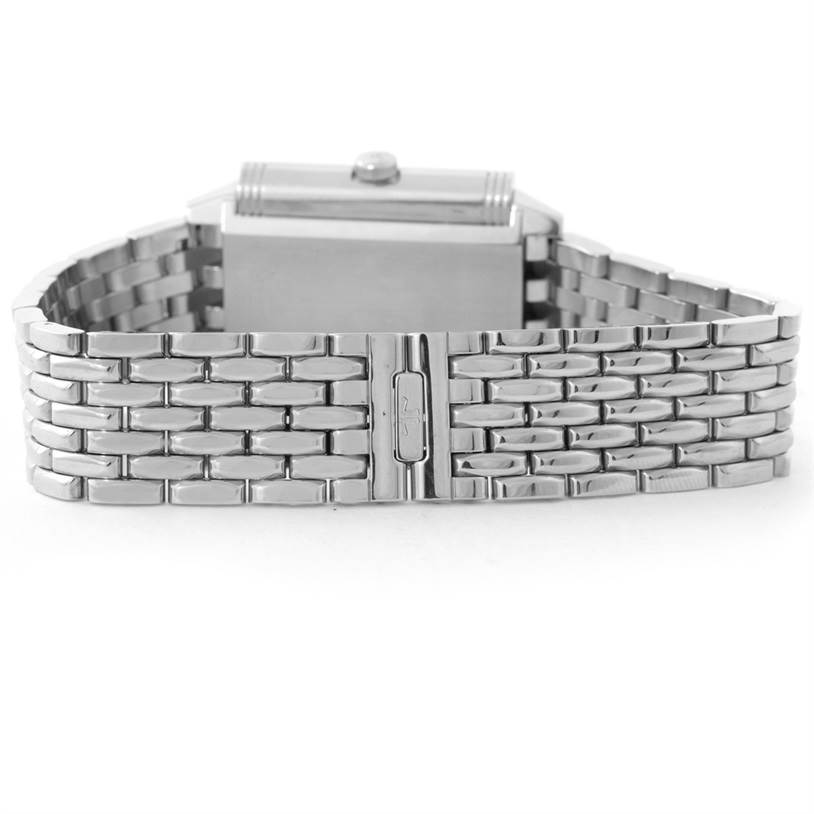 The image shows a Jaeger-LeCoultre Reverso watch from the back, highlighting its metal bracelet and clasp.