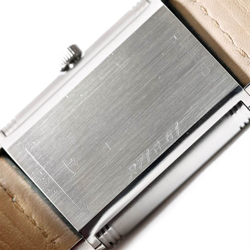 The image shows the reverse side of a Jaeger LeCoultre Reverso 271.8.61 Men's Stainless Steel Grey Dial 271.8.61 Men's Stainless Steel Grey Dial watch with its serial number and partial view of the leather strap.