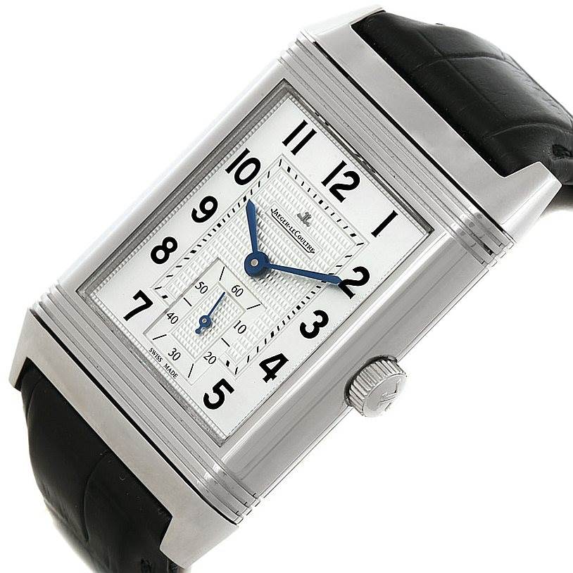 The image shows a Jaeger LeCoultre Reverso 273.8.04 Men's Stainless Steel Silver Dial 273.8.04 Men's Stainless Steel Silver Dial watch at an angled view, highlighting its face, crown, and black leather strap.