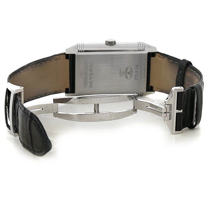 The image shows the back view of a Jaeger-LeCoultre Reverso watch, highlighting the case back and the deployment clasp.