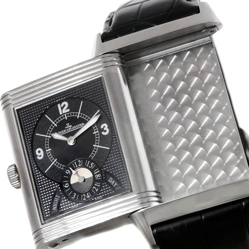 The image shows a Jaeger-LeCoultre Reverso watch with its case partially open to display the dial and inner detailing.