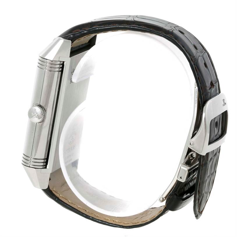 The image shows a side view of a Jaeger LeCoultre Reverso 273.8.85 Men
s Stainless Steel Silver Dial 273.8.85 Men
s Stainless Steel Silver Dial watch, highlighting the crown, case, and leather strap.