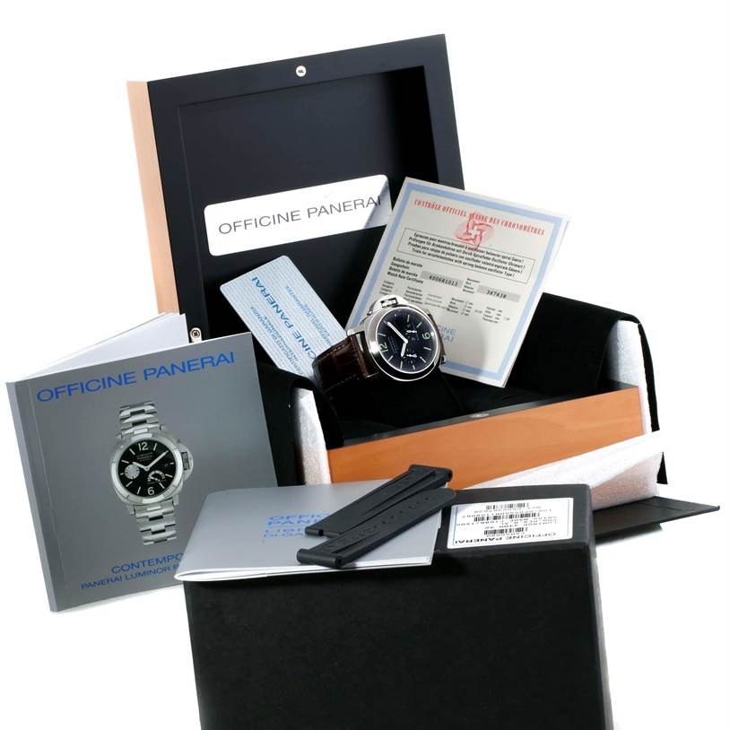 The image shows a Panerai Luminor PAM00090 Men
s Stainless Steel Black Dial PAM00090 Men
s Stainless Steel Black Dial watch with its box, manuals, warranty cards, and an extra strap.