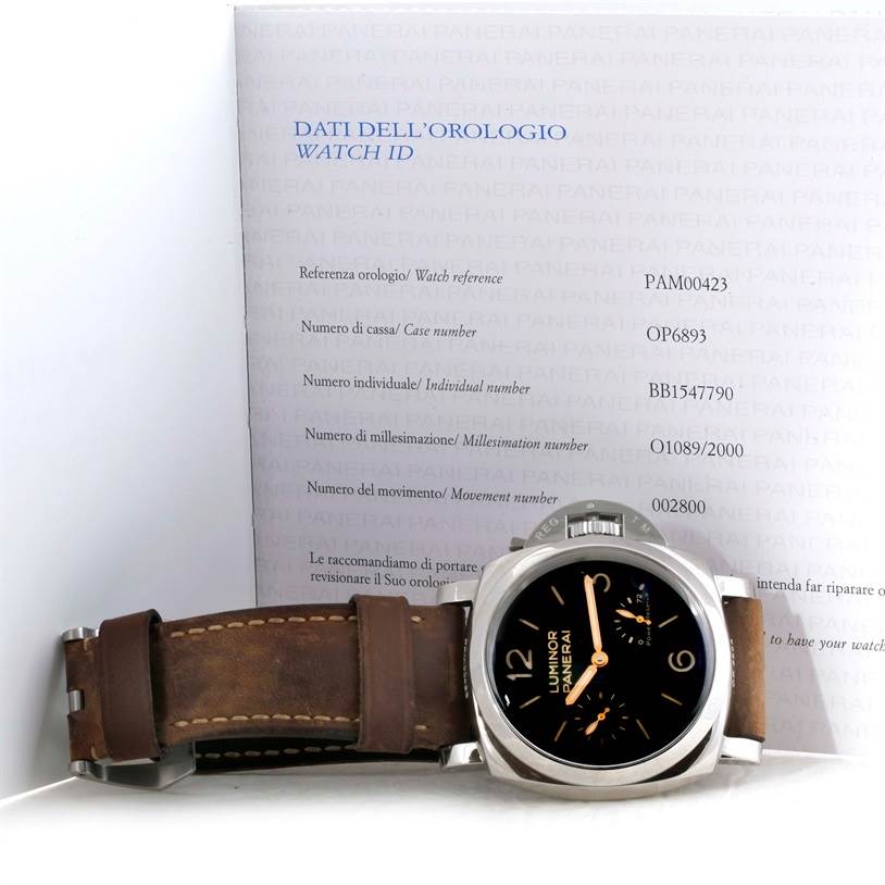 The Panerai Luminor PAM00423 Men's Stainless Steel Black Dial PAM00423 Men's Stainless Steel Black Dial watch is displayed at a slight angle, showing its face and brown leather strap, with the ID card in the background.