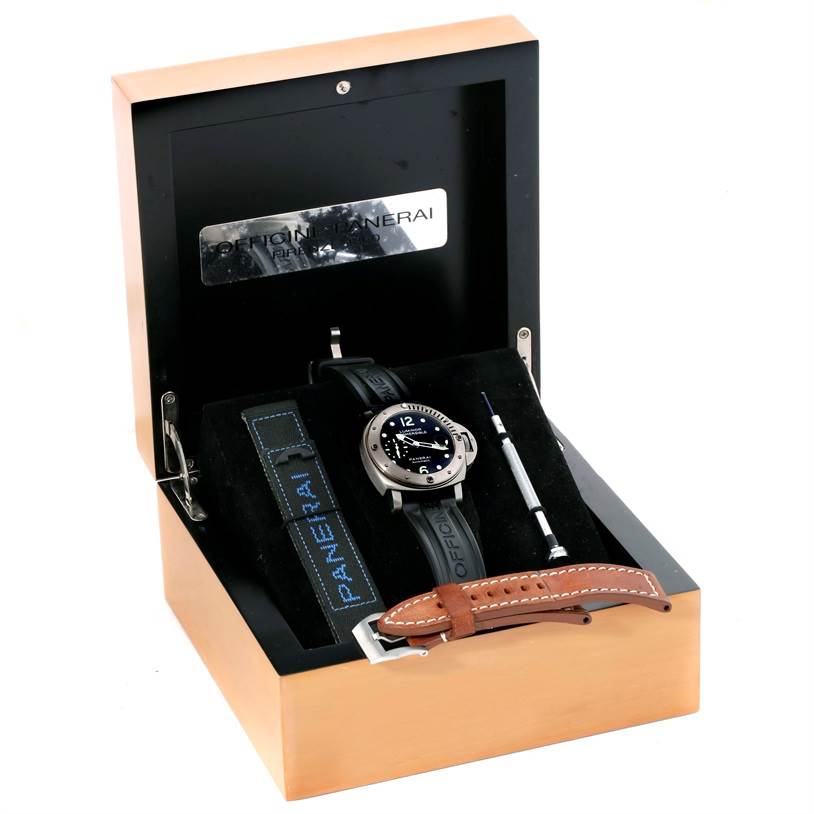 The image shows a Panerai Submersible PAM00025 Men's Titanium Black Dial PAM00025 Men's Titanium Black Dial model watch in its box, with additional straps and a tool included.