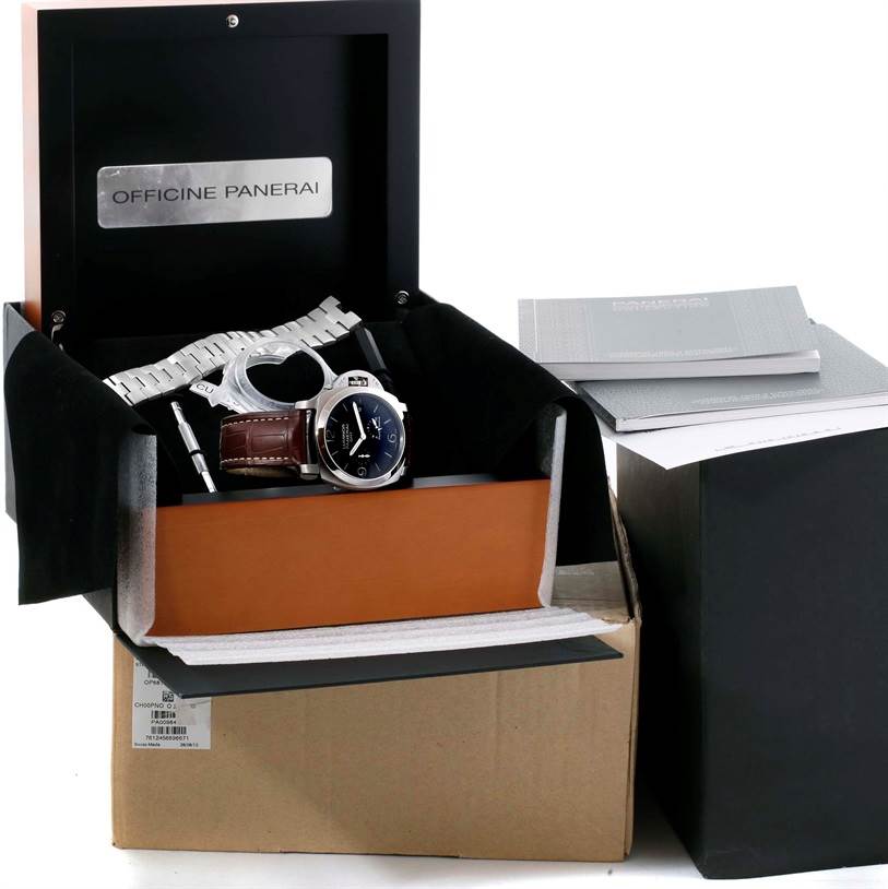The Panerai Luminor PAM00347 Men's Stainless Steel Black Dial PAM00347 Men's Stainless Steel Black Dial watch is displayed in an open box with additional accessories, including a metal strap and documentation.