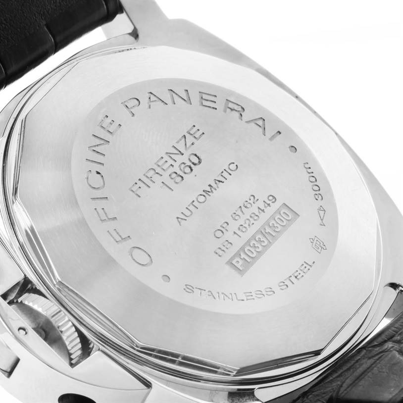 The image shows the back of a Luminor model watch by Panerai, displaying the engraving details and part of the strap.
