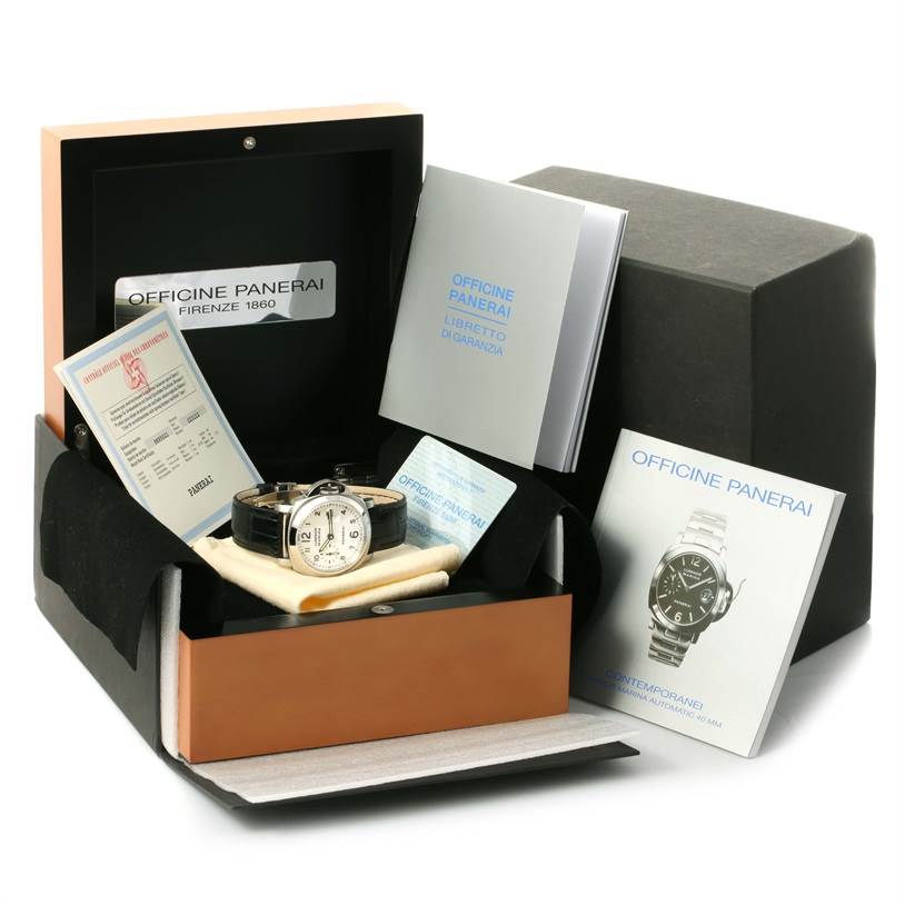 The image shows a Panerai Luminor PAM00049 Men's Stainless Steel White Dial PAM00049 Men's Stainless Steel White Dial watch in its box with accessories including manuals and certificates, taken from a front angle.