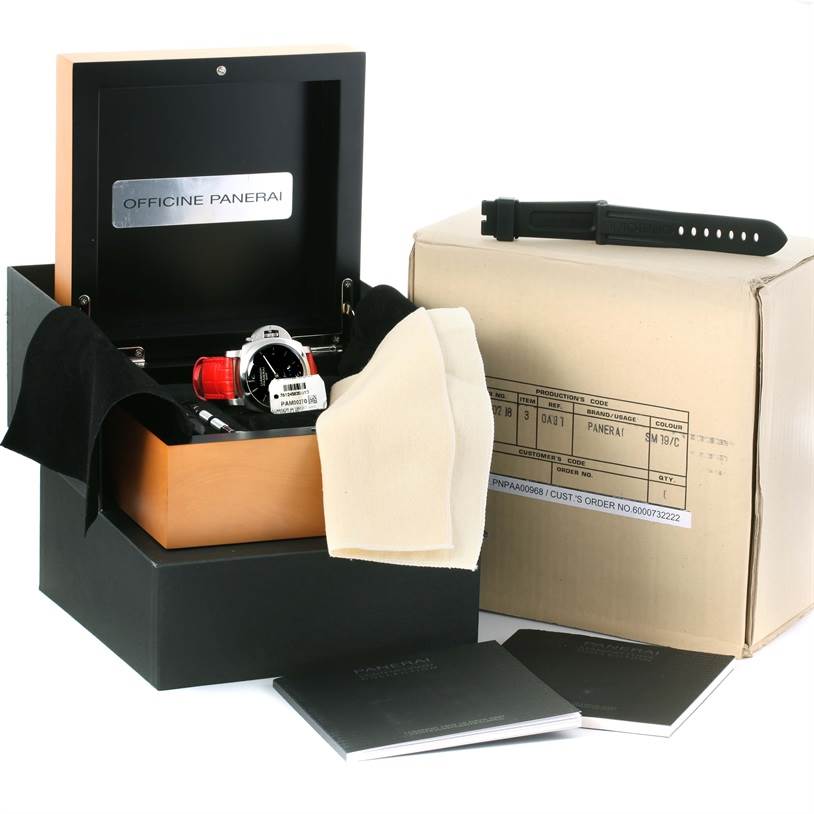 This image shows a Panerai Luminor PAM00270 Men's Stainless Steel Black Dial PAM00270 Men's Stainless Steel Black Dial watch in its box with accessories, including manuals, a strap, and a cleaning cloth.