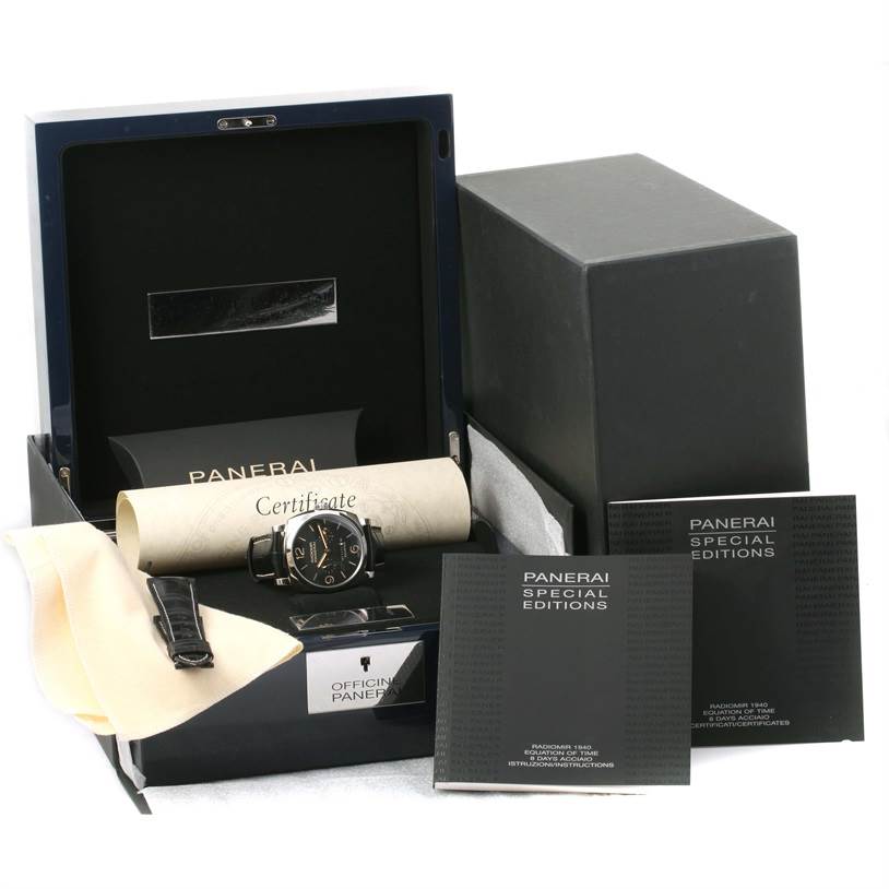 The image shows a Panerai Radiomir PAM00516 Men
s Stainless Steel Black Dial PAM00516 Men
s Stainless Steel Black Dial watch with its box, certificate, manuals, and a cleaning cloth from a slightly elevated angle.