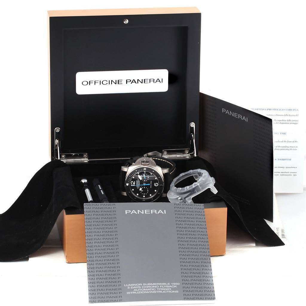 The image shows an unboxed Panerai Submersible PAM00615 Men's Titanium Black Dial PAM00615 Men's Titanium Black Dial watch with accessories, manuals, and tools from a frontal angle.