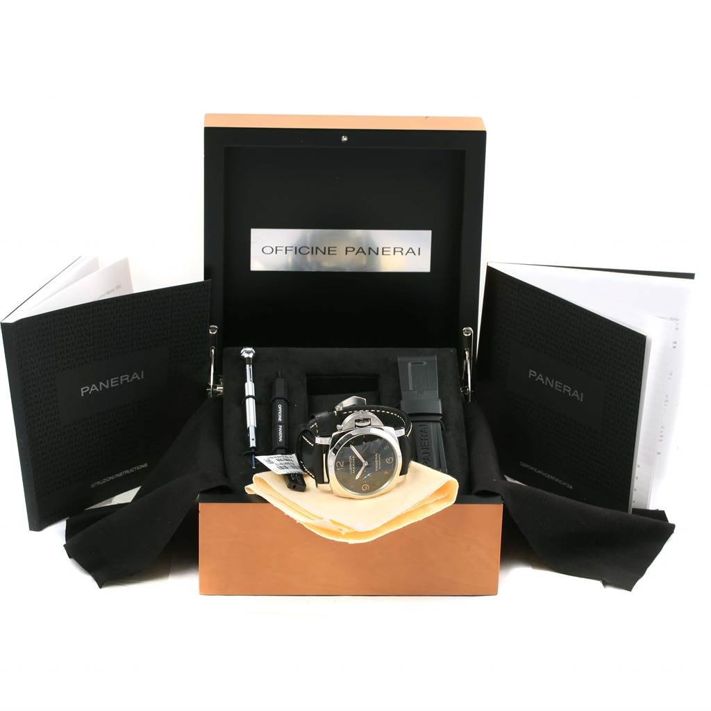 The image shows an open box with a Panerai Luminor PAM01359 Men
s Stainless Steel Black Dial PAM01359 Men
s Stainless Steel Black Dial watch, additional straps, a tool, booklets, and a polishing cloth.