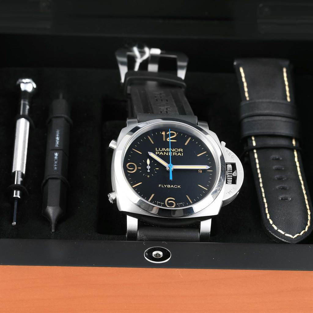 The image shows a Panerai Luminor PAM00524 Men's Stainless Steel Black Dial PAM00524 Men's Stainless Steel Black Dial watch, a strap, and tools from a top-down angle.