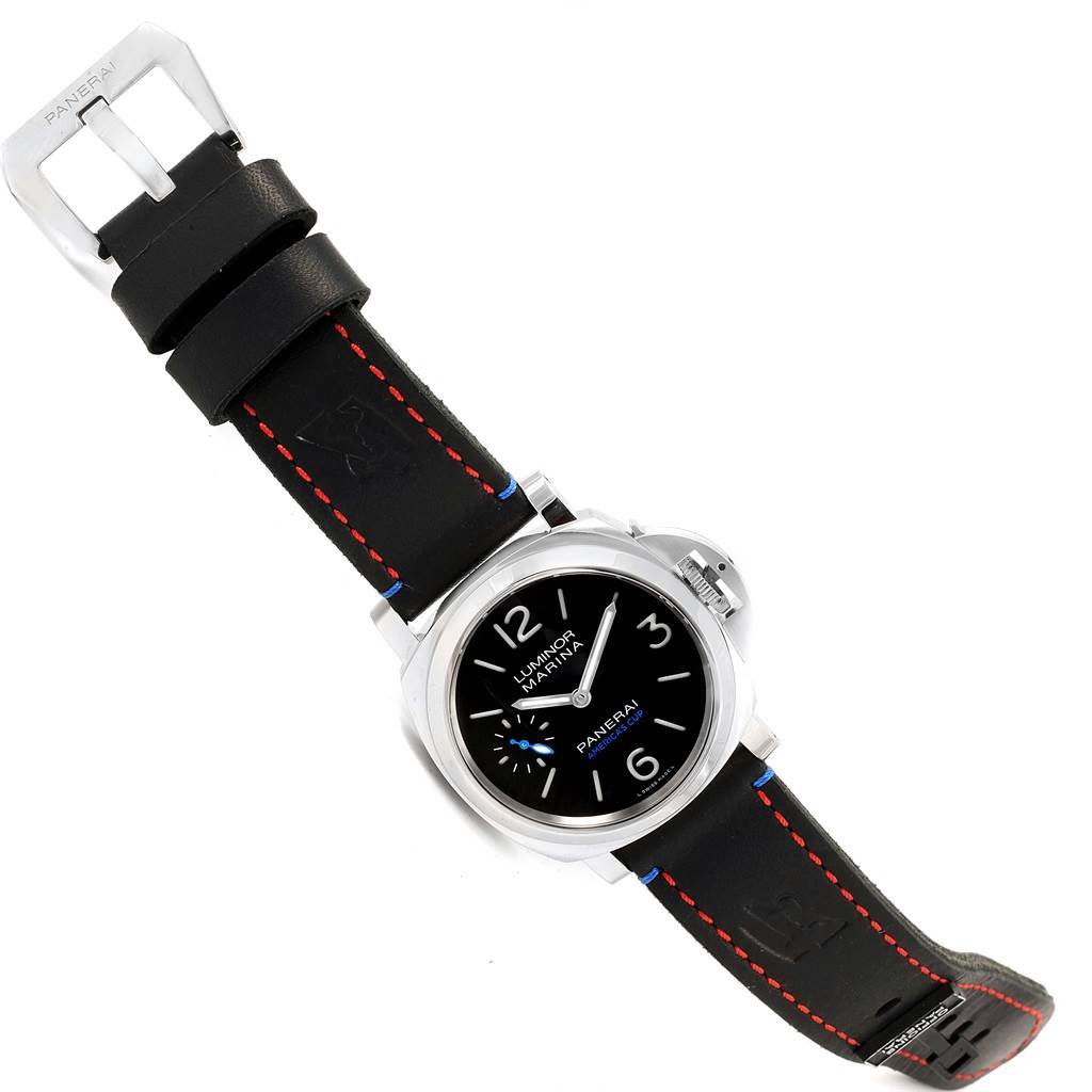 The image shows a Panerai Luminor PAM00724 Men's Stainless Steel Black Dial PAM00724 Men's Stainless Steel Black Dial watch from a top-down angle, displaying its face, bezel, and black strap with red stitching.