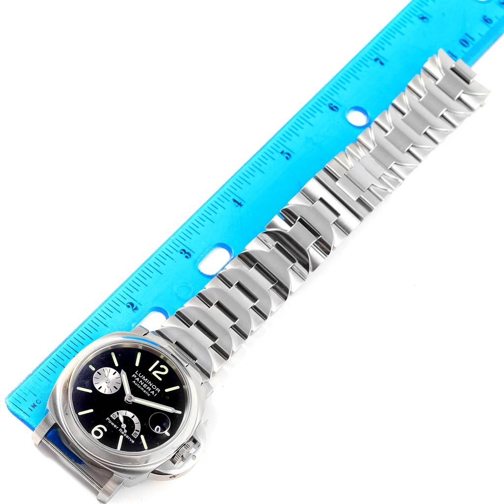 The Panerai Luminor PAM00126 Men's Stainless Steel Black Dial PAM00126 Men's Stainless Steel Black Dial watch is displayed flat with its face and metal bracelet visible alongside a blue ruler for scale.