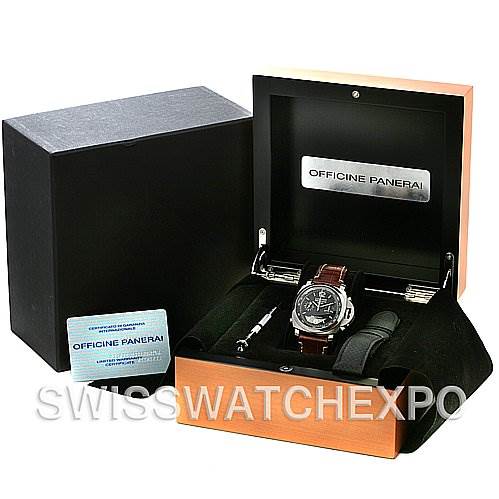 The image shows a Panerai Luminor PAM213 OR PAM00213 Men
s Stainless Steel Black Dial PAM213 OR PAM00213 Men
s Stainless Steel Black Dial watch in its box, along with an additional strap, a screwdriver, and a warranty card.