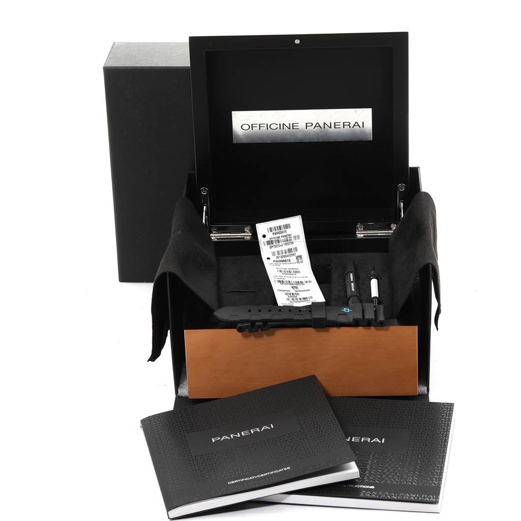 The image shows an open Panerai Submersible PAM00615 Men's Titanium Black Dial PAM00615 Men's Titanium Black Dial watch box with accessories, including tools, a booklet, and an additional strap.