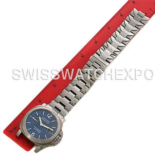 The image shows a top-down view of a Panerai Luminor PAM283 OR PAM 283 OR PAM 00283 Men's Titanium Blue Dial PAM283 OR PAM 283 OR PAM 00283 Men's Titanium Blue Dial watch with a metal bracelet, placed next to a red ruler.