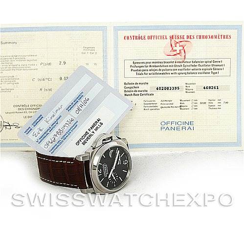 The image shows a Panerai Luminor PAM241 Men
s Stainless Steel Black Dial PAM241 Men
s Stainless Steel Black Dial watch at an angle showcasing its face and strap, along with brand certification cards in the background.