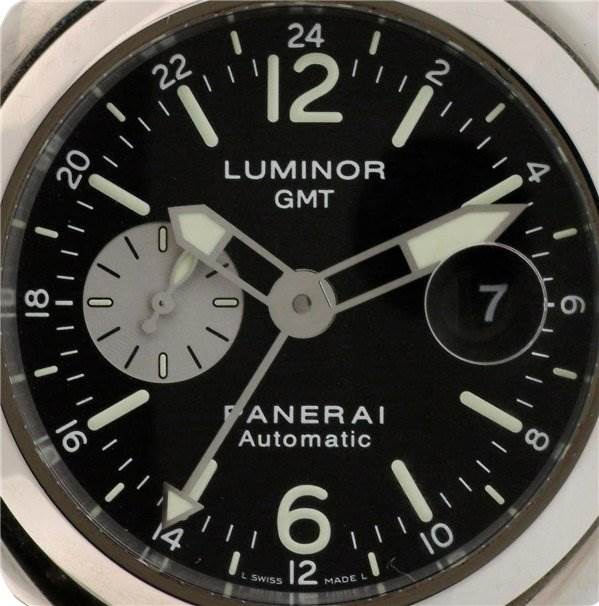 The image shows a close-up of the dial of a Panerai Luminor PAM88 Men's Stainless Steel Black Dial PAM88 Men's Stainless Steel Black Dial GMT watch, highlighting the hour markers, hands, and date window.
