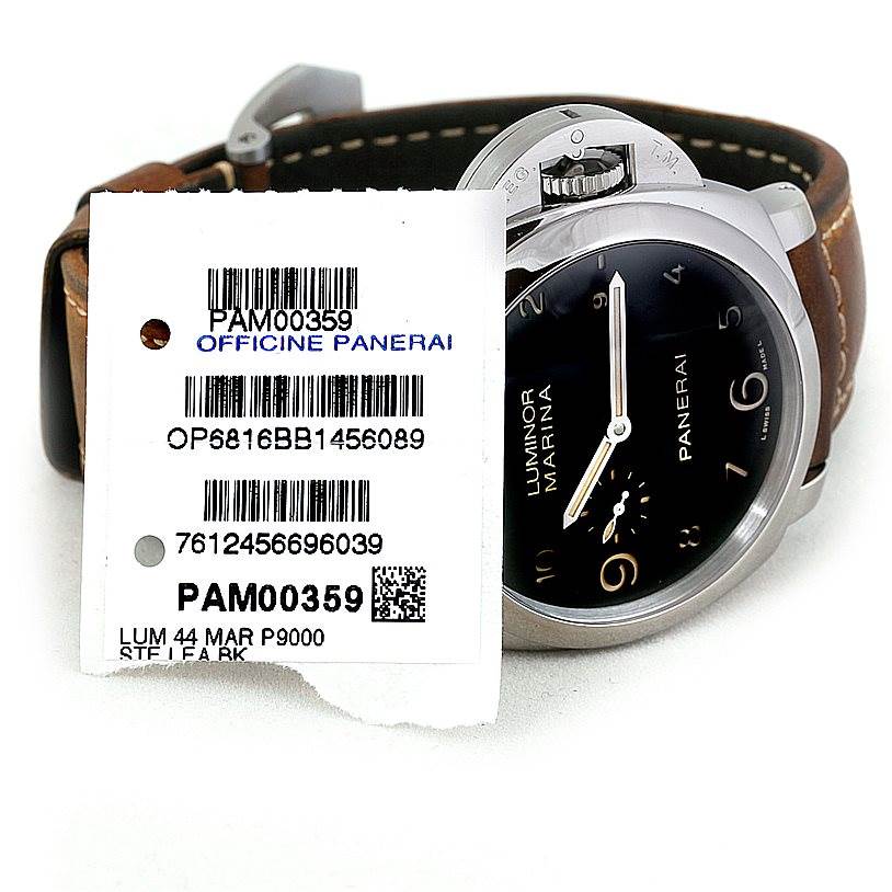 The image shows a close-up of a Panerai Luminor PAM00359 Men
s Stainless Steel Black Dial PAM00359 Men
s Stainless Steel Black Dial model, highlighting the dial, crown, and leather strap along with its tags.