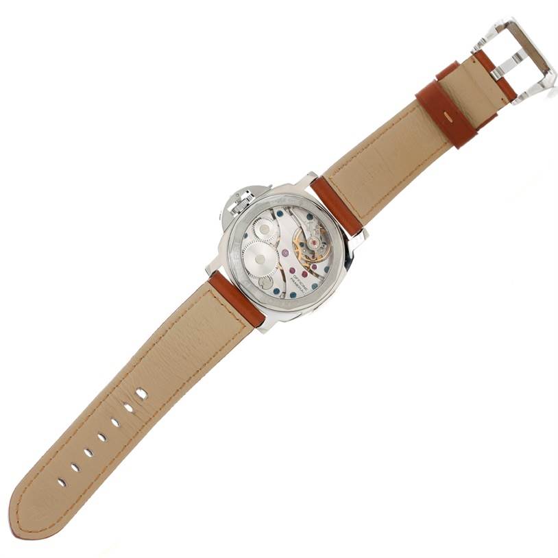 This Panerai Luminor PAM00112 Men
s Stainless Steel Black Dial PAM00112 Men
s Stainless Steel Black Dial watch is shown from the back, revealing its transparent case back and movement, with a beige leather strap.