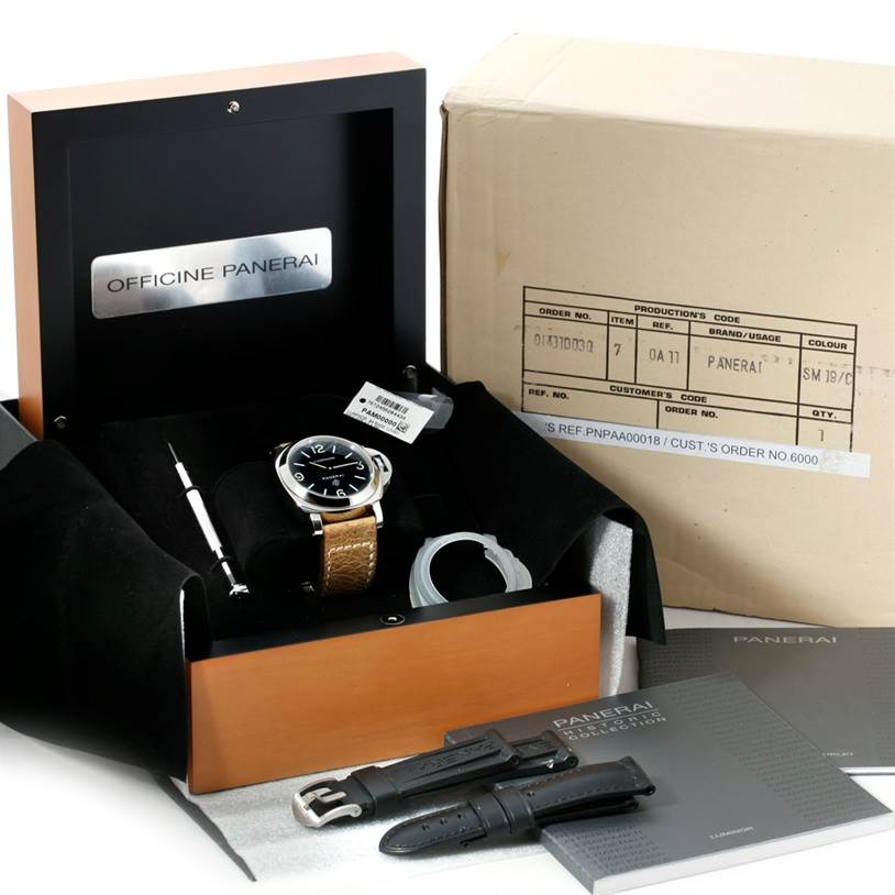 This image shows a Panerai Luminor PAM00000 Men
s Stainless Steel Black Dial PAM00000 Men
s Stainless Steel Black Dial watch with its box, additional straps, and tools, viewed from a front angle.
