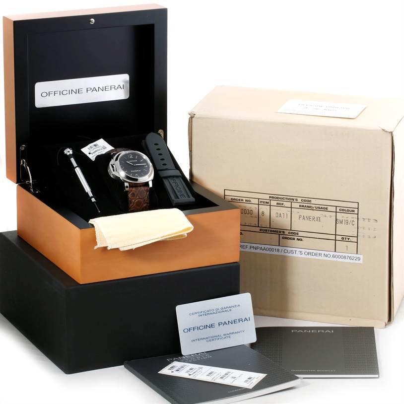 The image shows a Panerai Luminor PAM00219 Men's Stainless Steel Black Dial PAM00219 Men's Stainless Steel Black Dial watch in its box, with an extra strap, tools, and warranty papers.